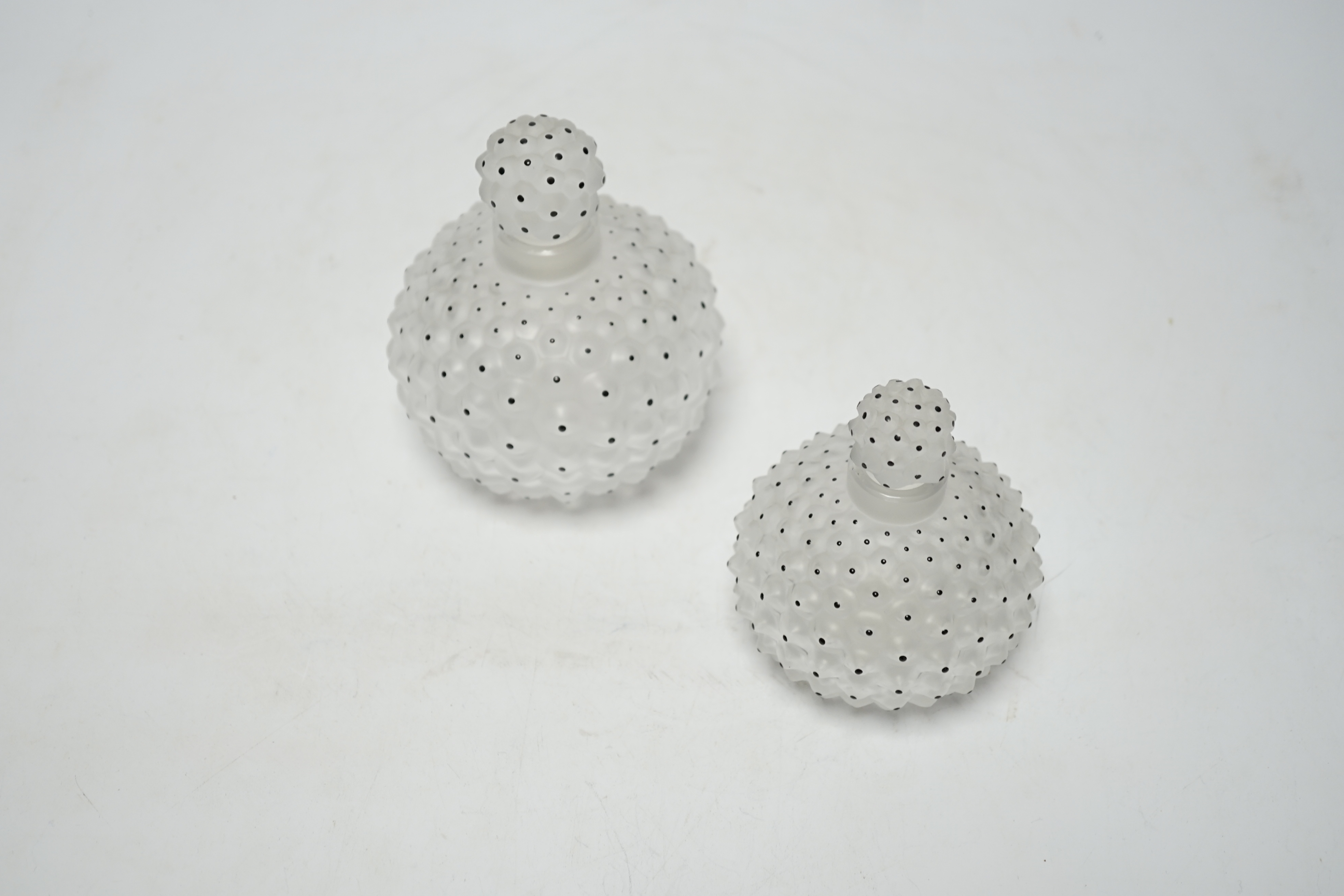 Two Lalique graduated cactus pattern glass scent bottles and stoppers, one with label to the base, largest 12cm high